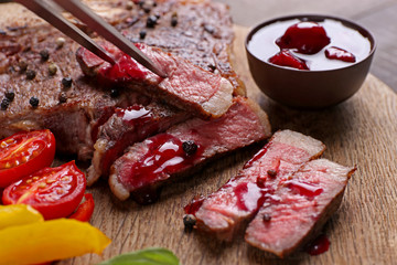 Grilled steak with vegetables and sauce, closeup