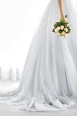 Bride in beautiful dress holding wedding bouquet