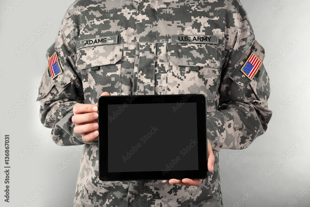 Poster Soldier holding tablet. Military education concept