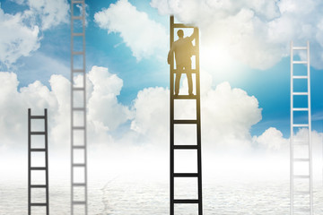 Businessman climbing stairs against the sky
