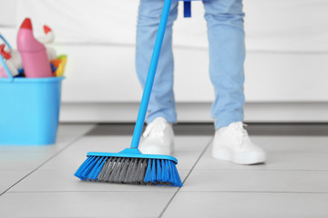 Close up view of woman cleaning floor at home