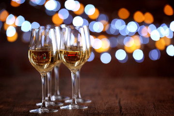 Glasses of wine in a row on bokeh background