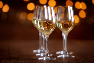 Glasses of wine in a row on bokeh background