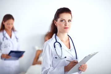 Woman doctor with folder standing at hospital