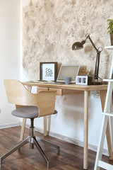 Workplace with laptop on table in modern room