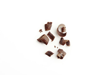 Dark chocolate shavings on white background