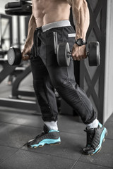 Topless man with with dumbbells