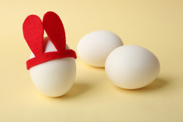 Easter eggs with funny decor on color background