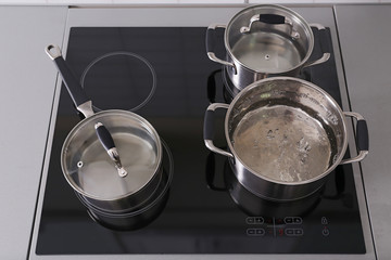 Metal pans on modern kitchen stove