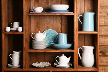 Wooden shelves with white and blue rustic dinnerware