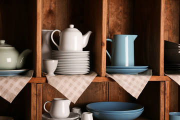 Wooden shelves with white and blue rustic dinnerware