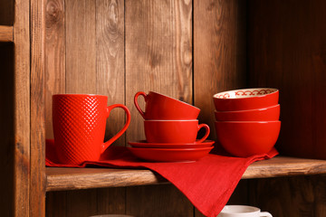 Wooden shelves with red rustic dinnerware