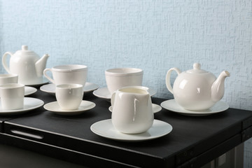 Simple white tea set on black wooden table