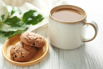 Delicious homemade cookies and cup of coffee on wooden table