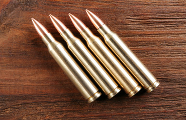 Bullets on wooden background