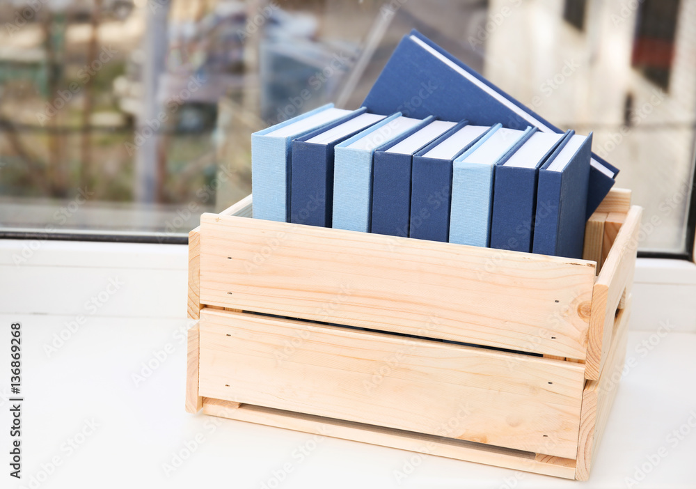 Sticker Wooden box with books on windowsill