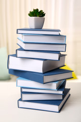Stack of books on white wooden table