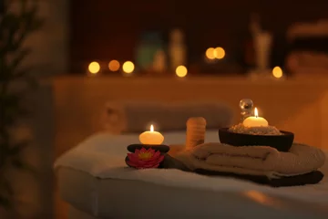 Tuinposter Natural treatments and alight candles in spa salon © Africa Studio
