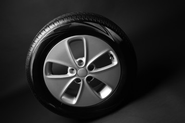 Modern car wheel on black background