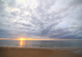 Naklejka na ściany i meble Beautiful sunrise in the sea