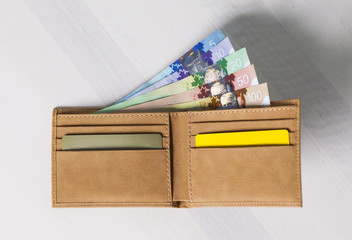 Canadian Dollars and credit cards in mustard coloured leather wallet