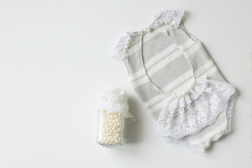 Clothing for newborns rasschita beads on a white background. handmade