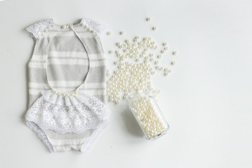 Clothing for newborns rasschita beads on a white background. handmade
