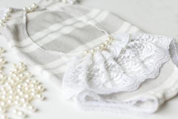 Obraz na płótnie Canvas Clothing for newborns rasschita beads on a white background. handmade