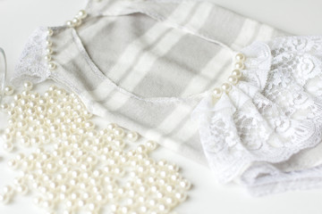 Obraz na płótnie Canvas Clothing for newborns rasschita beads on a white background. handmade