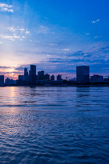 Obraz premium City Skyline By River Against cloudy Sky in Shanghai,China.