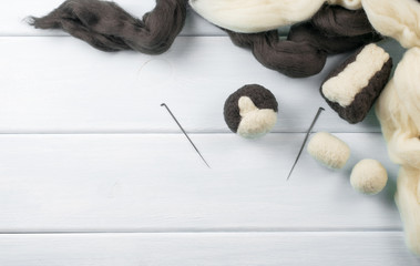Workplace with tools, needle and skeins of wool for felting toys.