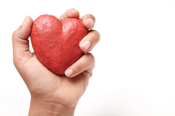 Hand holding red heart.