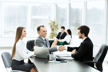 business partners are discussing a plan of cooperation in the workplace in the office