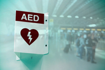 AED Automated External Defibrillator sign at an airport. double exposure