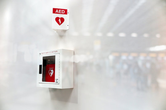 AED Automated External Defibrillator sign at an airport. double exposure