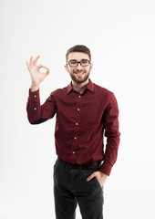 Naklejka premium Manager making the gesture OK on a white background.