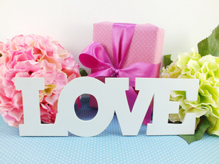 text love word copy with gift and flower close up