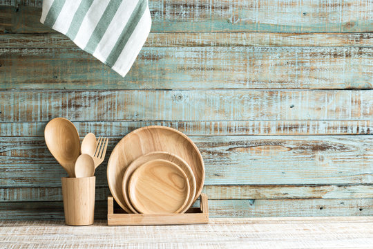 Kitchen cooking utensils in storage on the wood background