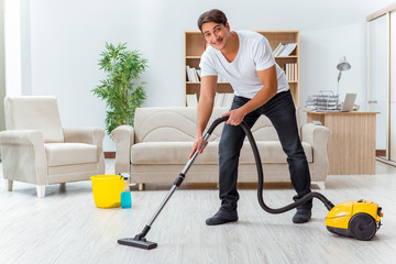 Man husband cleaning the house helping wife