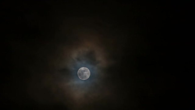 Ultra high definition 4k time lapse movie of moving snow moon moonrise with dark clouds at night 4096x2304 uhd