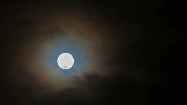 Ultra high definition 4k time lapse movie of moving snow moon moonrise with dark clouds at night 4096x2304 uhd