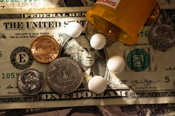 Pills and money prescription and medication cost for health care