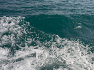 Fototapeta na wymiar blue sea stormy waves with white foam
