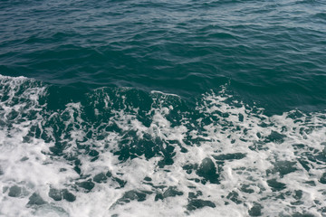 Fototapeta na wymiar blue sea stormy waves with white foam