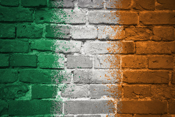 painted national flag of ireland on a brick wall