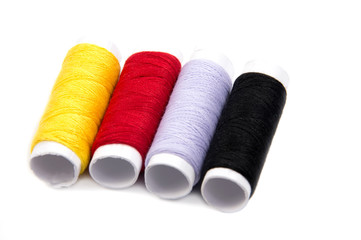 Colorful spools of thread isolated on white background
