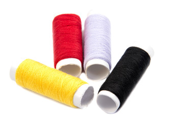 Colorful spools of thread isolated on white background