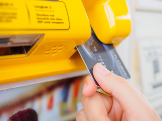 Hand is holding the credit card and insert to the machine