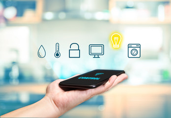 Hand holding mobile with Smart home control icon feature with bl