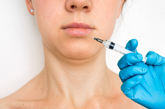 Woman gets injection in her face - cosmetic concept